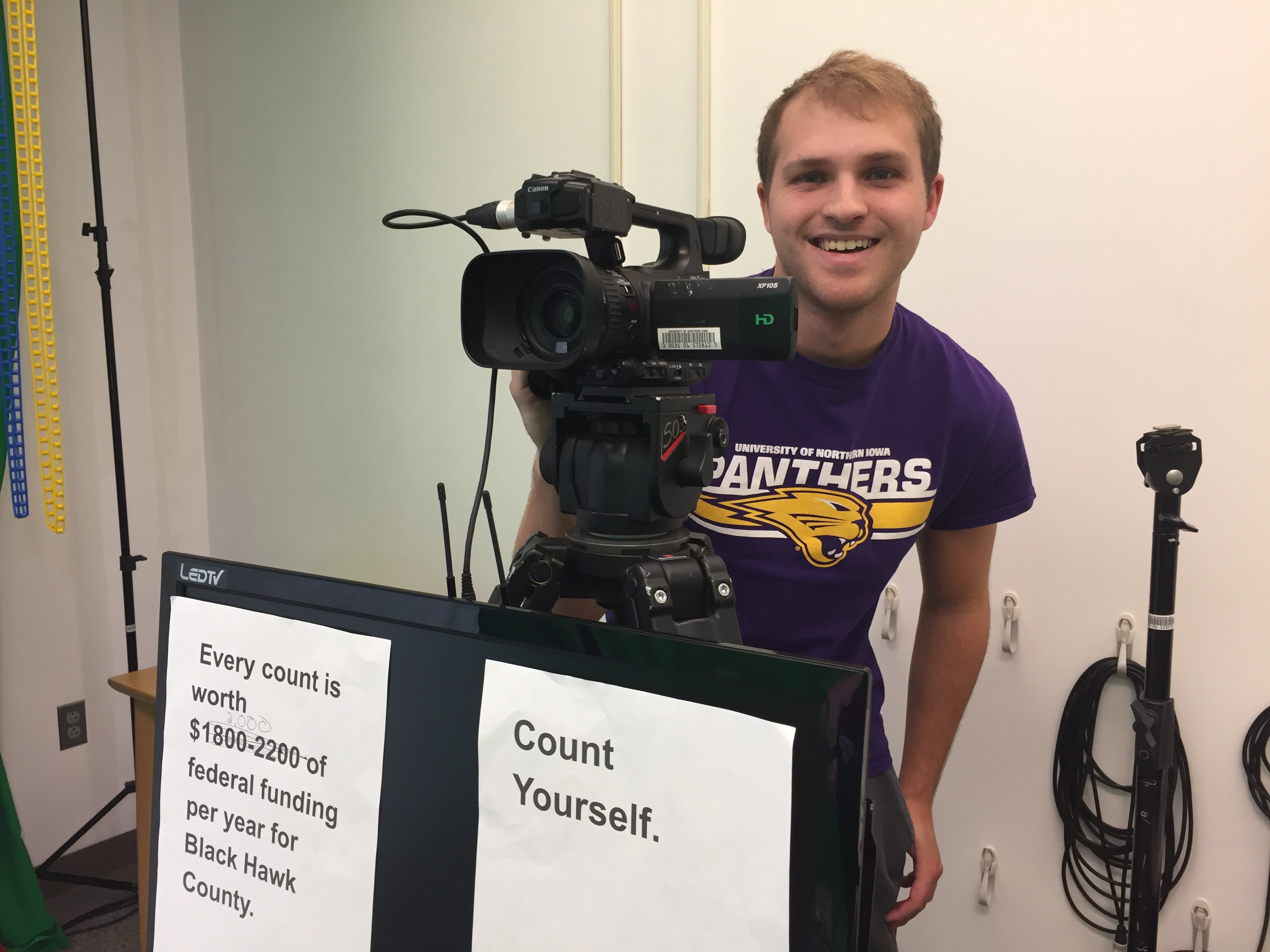Student behind a video camera