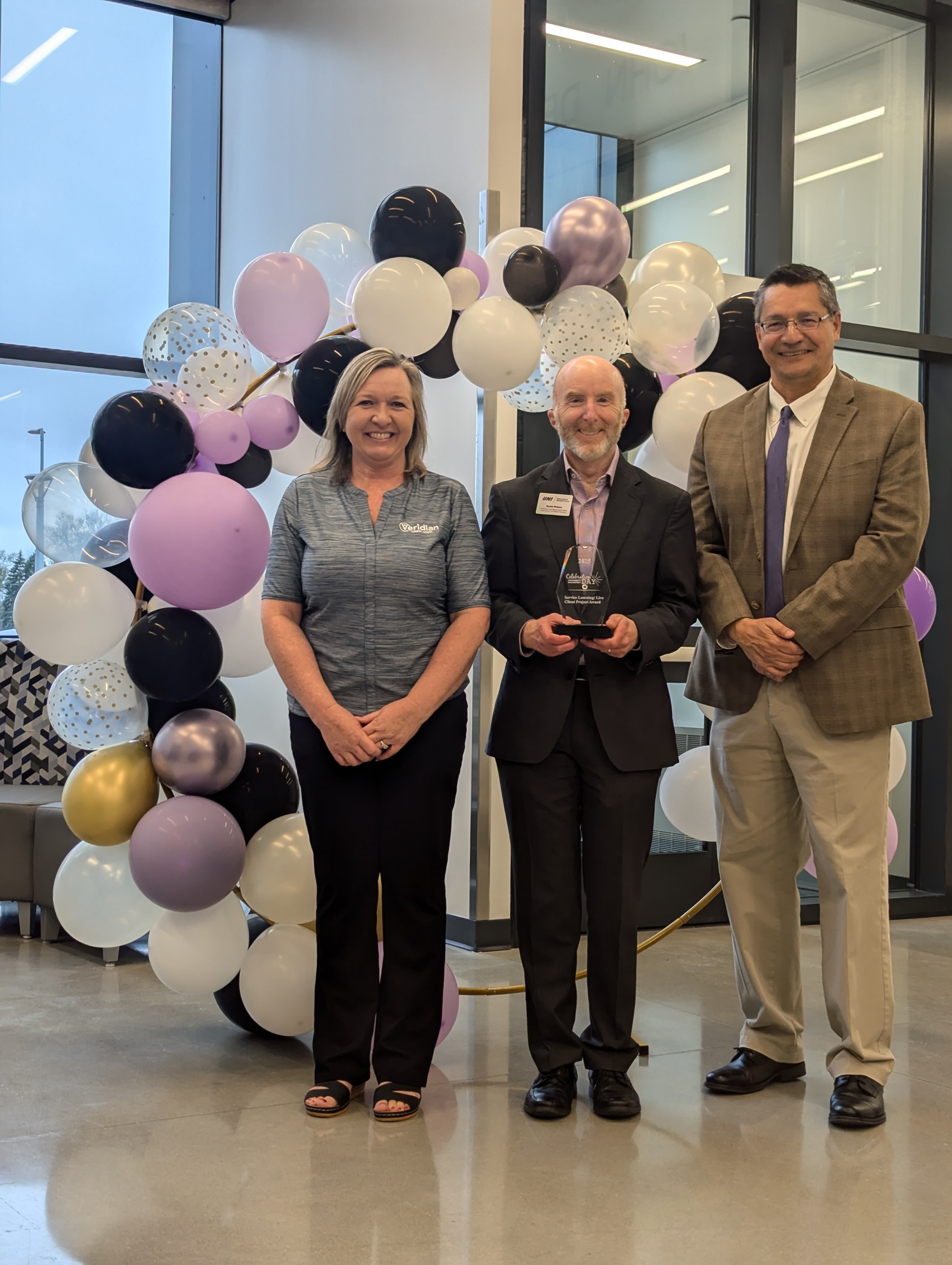 Scott Peters poses with Julie Gage from Veridian and Provost Herrera
